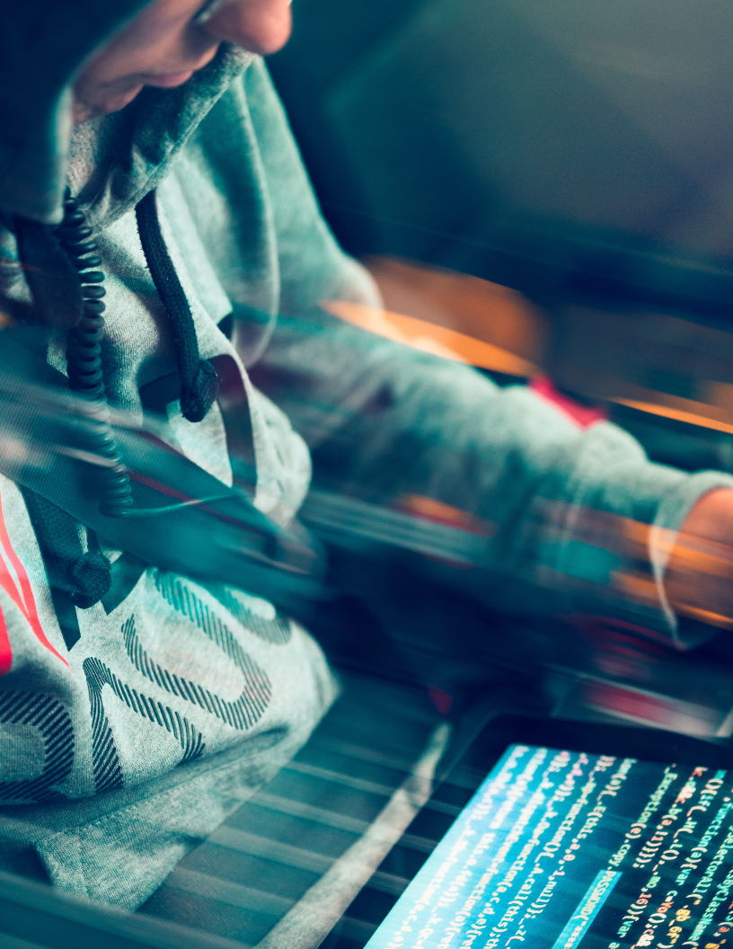 Hacker reading code on a tablet Hacker reading code on a tablet