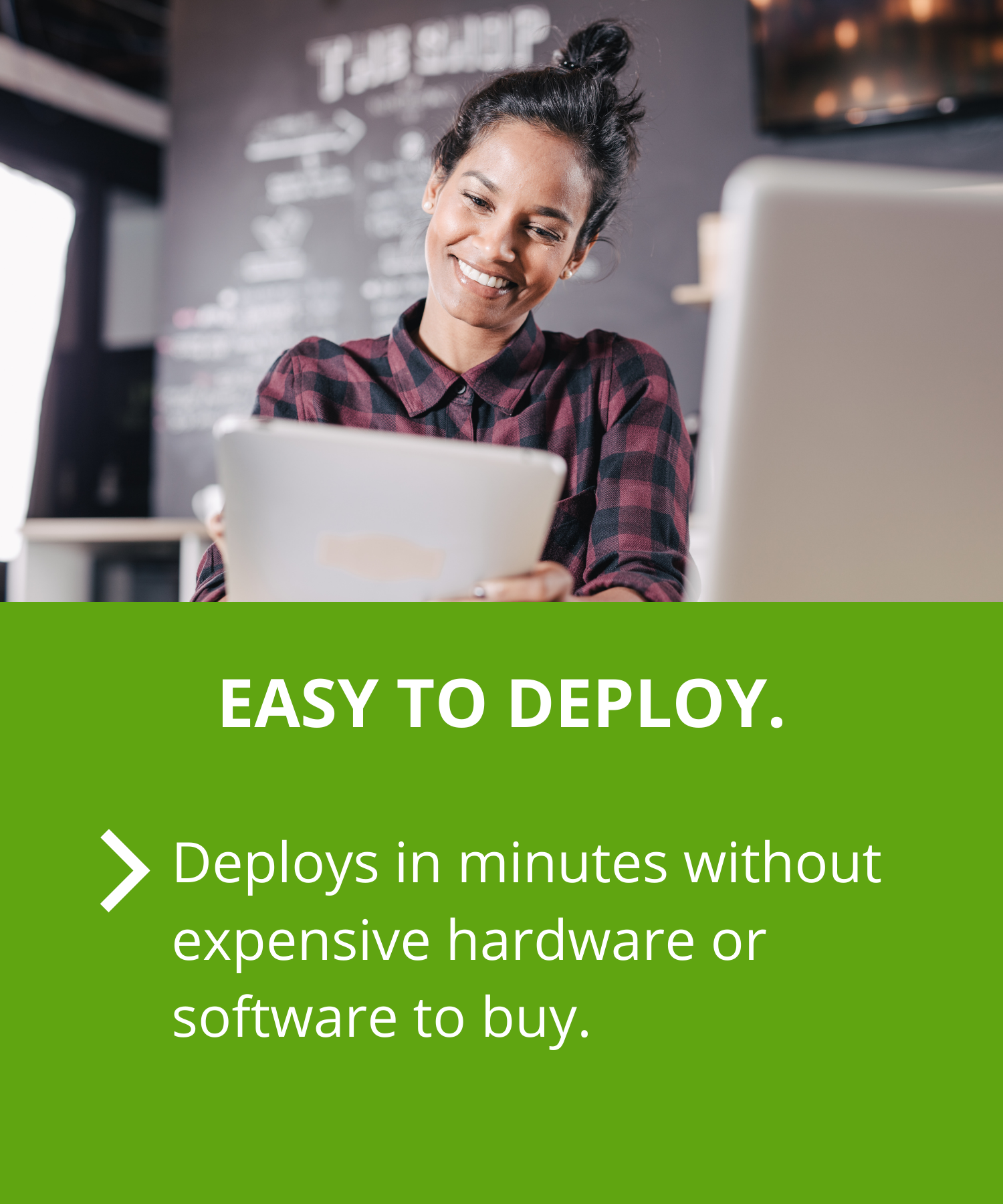 Woman smiling at tablet device because her business data is secure Woman smiling at tablet device because her business data is secure